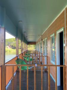 a deck of a train with tables and chairs at Don Det SODA RiverSide Guesthouse in Ban Donsôm Tai