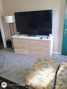 a large flat screen tv sitting on top of a dresser at open arms in Elizabeth City
