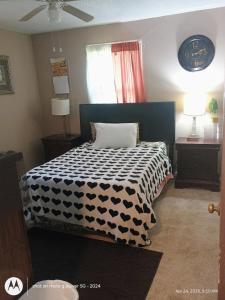 a bedroom with a bed with a black and white comforter at open arms in Elizabeth City
