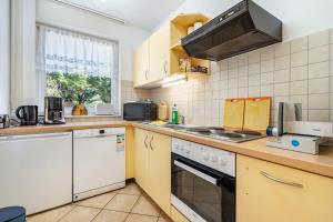 a kitchen with white appliances and a window at Gästezimmer - Meißen in Meißen