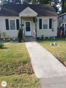 a house with a sidewalk leading to the front door at open arms in Elizabeth City