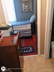a small room with a bed and a desk and a bedroom at open arms in Elizabeth City