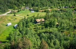 an aerial view of a house in the middle of a forest at Cozy log cabin in Geiranger in Geiranger