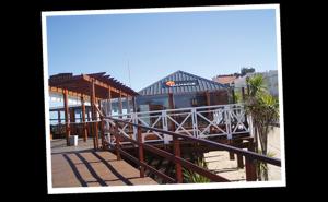 a dock with a building with a train on it at Punta Gesell in Villa Gesell