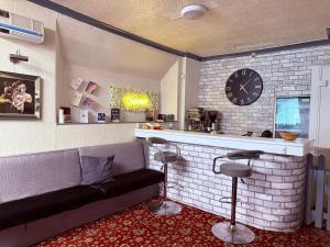 a living room with a couch and a clock on the wall at The Aberford in Blackpool