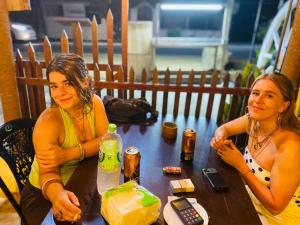 two women sitting at a table with a cake at Calm Night Surf Stay in Arugam Bay +43 photos
