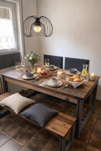 a wooden table with food and candles on it at Bollenhut 1 in Bad Wildbad +12 photos