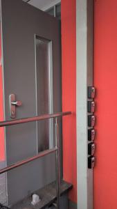 a room with a red wall and a staircase at Pension Quartier 11 in Waren +16 photos