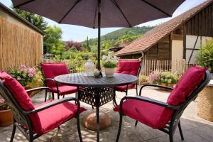 a table with chairs and an umbrella on a patio at Bollenhut 1 in Bad Wildbad