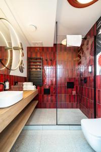 a bathroom with red tiles and a shower at Muselet Adults Only in Świnoujście +45 photos