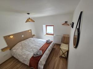 a bedroom with a large bed and a window at La vallée de la bruche in Wisches