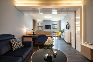 a living room with a couch and a table at Muselet Adults Only in Świnoujście