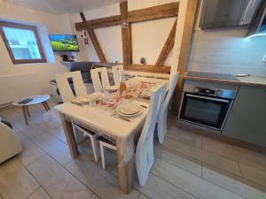a kitchen and dining room with a table and chairs at La vallée de la bruche in Wisches
