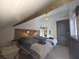 a bedroom with two beds and a counter in it at La vallée de la bruche in Wisches