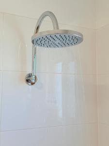 a shower with a shower head in a bathroom at 'Your Place on Davidson' Uno in Mount Isa +8 photos