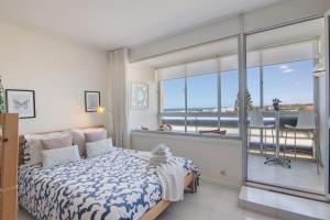 a bedroom with a bed with a view of the ocean at Algarve Vilamoura Apartment in Quarteira