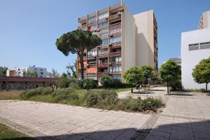 a building with a sidewalk in front of it at Algarve Vilamoura Apartment in Quarteira