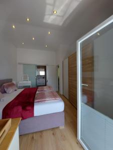 a bedroom with a bed and a sliding glass door at Panorama House Opatija in Donji Rukavac