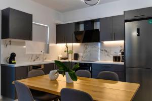 a kitchen with a wooden table and a refrigerator at Kaliva Villa in Kerames