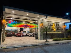 a hotel argentinian sign in a parking lot at night at Hotel Magnolia cuetzalan in Cuetzalán del Progreso