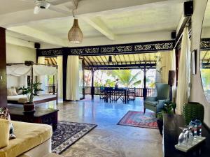 a living room with a couch and a table at The Palms - Seraya Shores Retreat Bali in Seraya