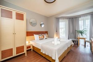 a hotel room with a bed and a desk at Muselet Adults Only in Świnoujście