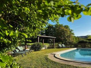 a swimming pool with lounge chairs and a gazebo at Laborie in Meyronne +17 photos