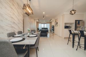 a dining room with a table and chairs at Teega Residence near Puteri Harbour Iskandar Puteri by Our Stay in Nusajaya