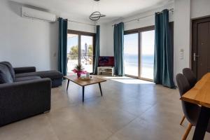 a living room with a couch and a table at Kaliva Villa in Kerames