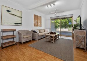 a living room with a couch and a table at Classic Beach House on Surfside - Pet Friendly in Pottsville