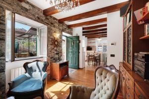 a living room with two chairs and a green door at Ca' Da Giuvanna in Sestri Levante
