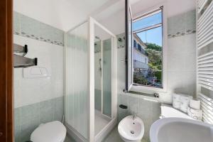 a bathroom with a toilet and a sink and a window at Ca' Da Giuvanna in Sestri Levante +31 photos