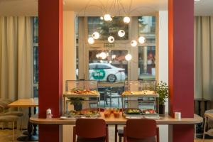 a restaurant with two tables with plates of food at Muselet Adults Only in Świnoujście