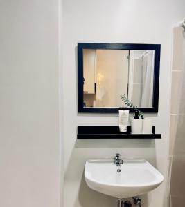 a bathroom with a sink and a mirror at Casa De Baguio in Town Center in Baguio