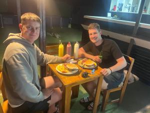 two men sitting at a table eating pancakes at Duval in Calama