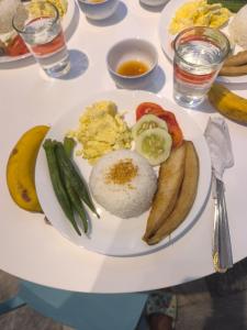 a plate of breakfast food on a table at Evan's Homestay in Basco