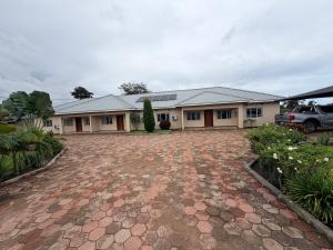 a house with a brick driveway in front of it at Destiny Executive Apartments in Solwezi