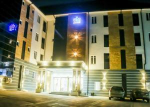 a building with a sign on the side of it at night at Abiis Hotel and Suites in Abeokuta