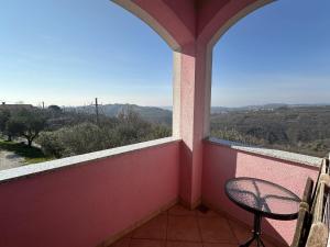 a small balcony with a chair and a window at Tourist Farm Robivera in Šmarje