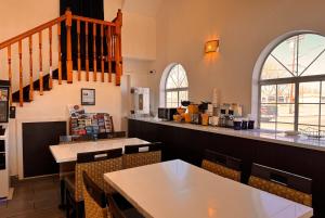 a restaurant with tables and chairs and a counter at Days Inn by Wyndham Bishop in Bishop