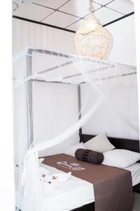 a bedroom with a bed with a canopy at Ocean Life Ayurvedic Villa in Talalla South