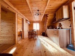 a kitchen and dining room in a log cabin at Cliffside - ქლიფსაიდი in Makhunts'et'i