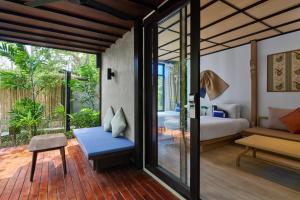 a bedroom with a bed and a living room at Homm Chura Samui in Chaweng +82 photos