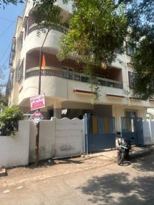 a motorcycle parked in front of a building at Peaceful & hygienic stay , Ideal for working professionals, Great for solo female travelers in Pune