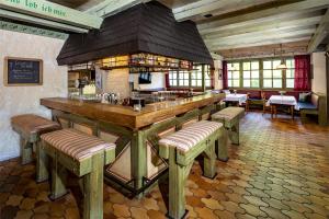 a restaurant with a bar with stools in a room at Sure Hotel by Best Western Rhoen Garden in Poppenhausen