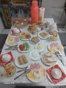 a table with plates of food on a table at Xonobod НОТЕL in Khiva