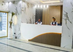 two men sitting at a counter in a lobby at Abiis Hotel and Suites in Abeokuta +37 photos