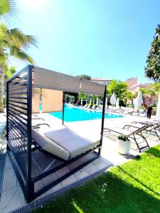 a swing bed next to a swimming pool at Hotel Bristol in Sottomarina