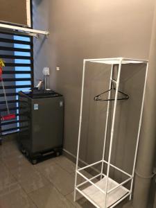 a metal stand in a room next to a refrigerator at Anna Vinhomes Grand Park in Ho Chi Minh City +26 photos