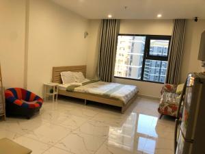 a bedroom with a bed and a large window at Anna Vinhomes Grand Park in Ho Chi Minh City